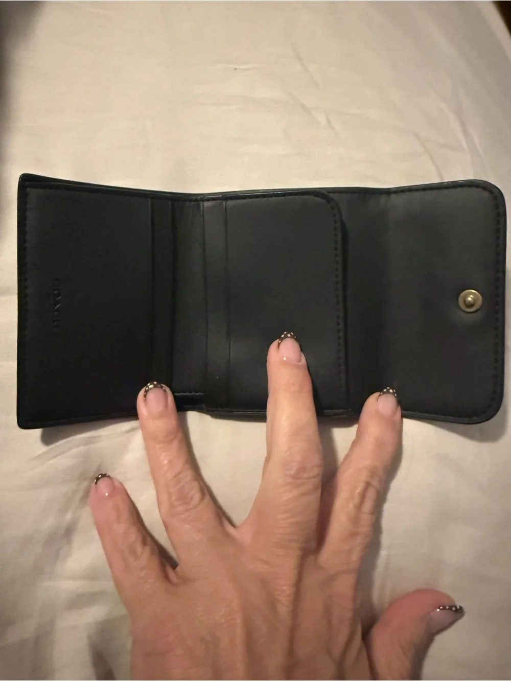 Coach Black Leather Compact Wallet with Gold 'C' Accent